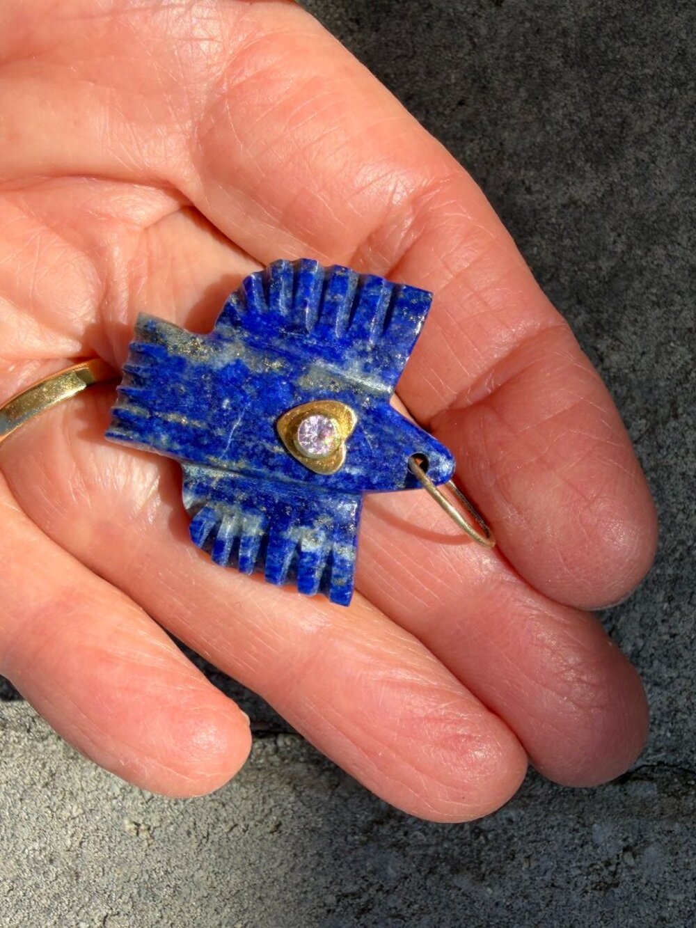 Hand-carved sodalite Thunderbird pendant with gold heart and pink gemstone